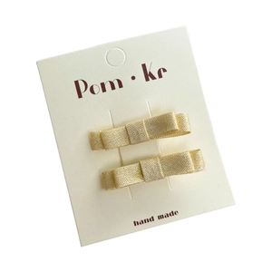 Lot de deux barrettes à cheveux nœud doré pailleté pour filles sur carte