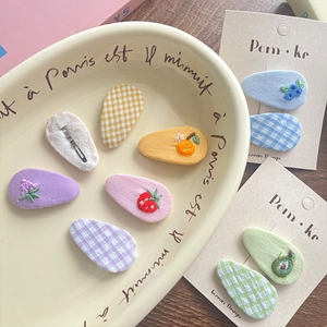 Cute Korean style embroidered plaid fruit hair clips set on a decorative beige tray