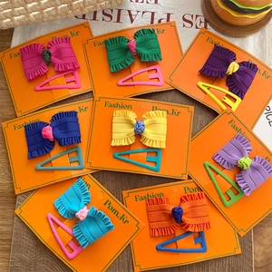 Colorful ribbon bow and matte triangle hair clips set on a fashion display card