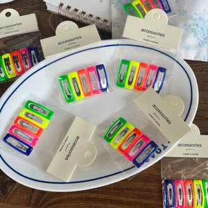 Detailed view of candy colored Korean style hair clips set in transparent packaging