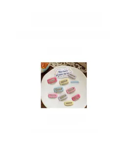 Detail view of colorful mini fabric-wrapped BB hair clips with 3cm length and 1.2g weight