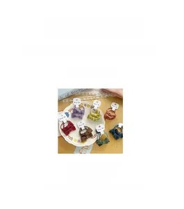 Detail showing seven colors of fabric bow hair ties with elastic bands and measurements