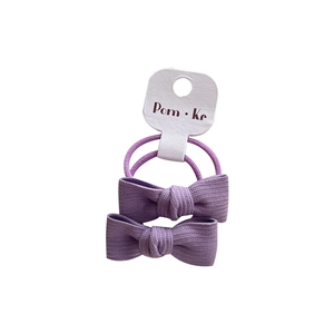 Light purple bow hair ties set with ribbed fabric texture and elastic bands on white background