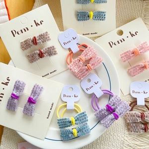 Handmade sequin bow hair ties and clips set in pastel colors on a display tray
