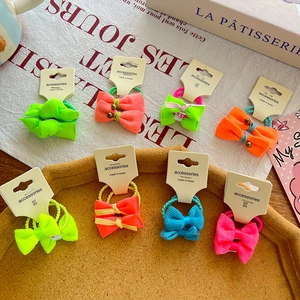 Neon knotted bow hair ties set with vibrant colors and elastic bands on display cards