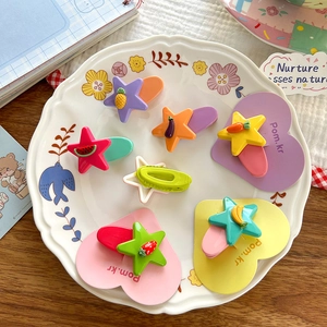 Cute Korean star hair clips with colorful fruit resin charms on a white lace plate