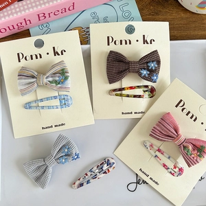Handmade bow hair clips set with houndstooth pattern and floral embroidery on cards