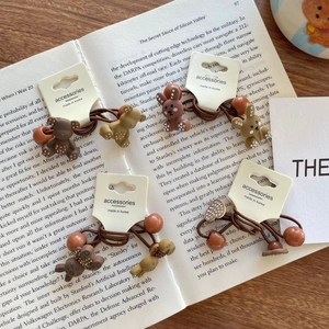 Set of brown elastic hair ties with cute resin bears and rabbits on a white card