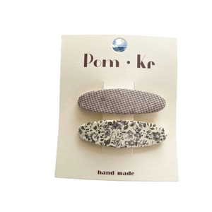 Floral print and checkered fabric hair clips set on display card for women
