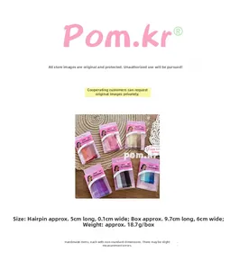 Detail view of 5cm glitter hair pins in various colors with plastic storage box