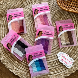 Sparkly glitter metal hair clips for kids in six colors displayed on a woven mat