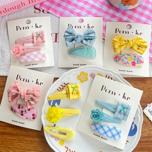 Charming children's hair clip set featuring plaid bows and embroidered cherry designs