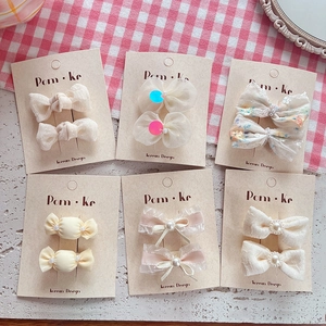 Close-up of pearl lace bows and sparkling tulle hair clips set for children