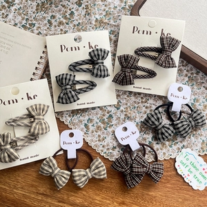 Plaid bow hair ties and clips set in black, brown and beige on vintage background