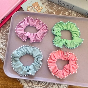 Four-piece set of pastel scrunchies with elegant pearl edges for ponytail styling