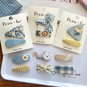 9-piece set of cute floral and plaid fabric hair clips for kids with cat and daisy patterns