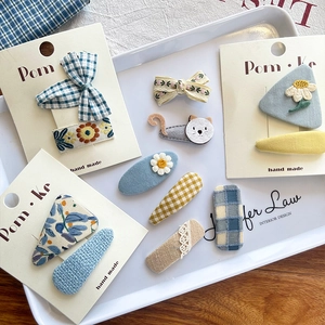 Detailed set of handmade children hair clips with bow, embroidery flowers and lace patterns