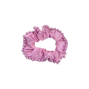 Pink elastic scrunchie with faux pearl trim on a white background for women