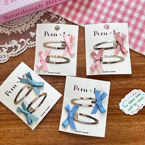 Set of 4 pairs of ballet style ribbon bow hair clips in pastel pink and blue colors
