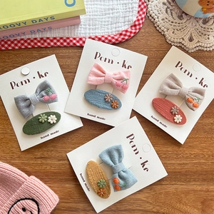 Handmade embroidered floral hair clips set for kids with bow and oval shapes on white card