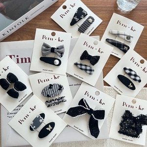 Chic black and white bow hair clips set with plaid patterns and faux pearl details