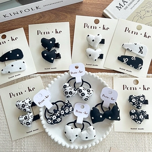 Bow hairpins and scrunchies set with heart and polka dot patterns on wood background