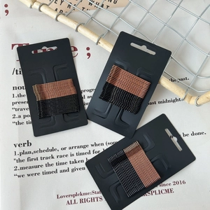 Minimalist black and rose gold wave hair pin set on three display cards for daily styling