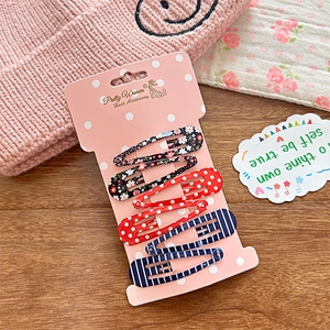 Detailed set of 6 floral, polka dot, and striped BB hair clips on pink display card