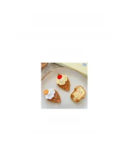 Close-up of handmade crochet ice cream hair clips for kids on a white ceramic plate