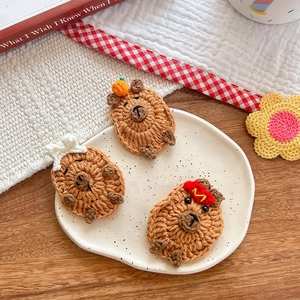 Handmade crochet Capybara hair clips featuring cute knitted animals with tiny decorations