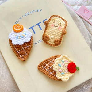 Handmade crochet ice cream and toast hair clips on a yellow notebook background