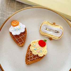 Detailed macro view of handmade crochet ice cream hair clips with metal duckbill clips