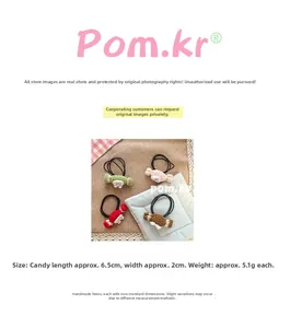 Detailed close-up of handmade knitted candy hair ties in four pastel colors for girls