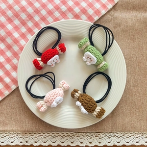 Handmade knitted candy rabbit hair bands for girls in four colors on a white ceramic plate