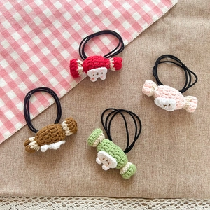 Detailed macro of handmade crochet candy hair ties in various sweet pastel colors