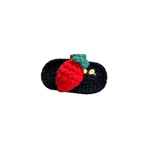 Handmade crochet strawberry hair clip with green leaves on black knitted base for kids