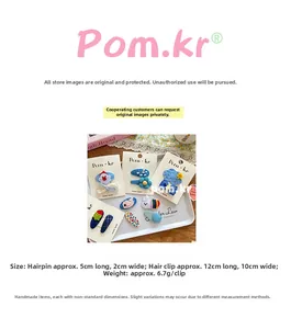Detail of colorful handmade fabric hair clips with cartoon shapes on display card