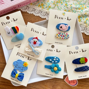 Detailed view of handmade felt hair clips for girls featuring cute bunny and flower motifs