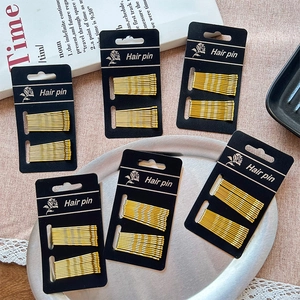 Elegant gold metal wave texture hair pin set on decorative card for women