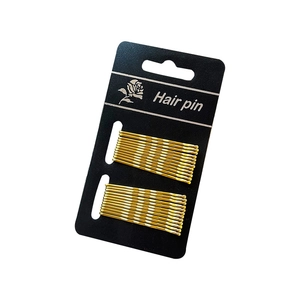 Set of 20 golden wave hair pins on black card packaging for minimalist hair styling