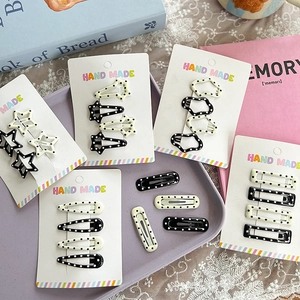 Black and white polka dot hair clips in star and cloud shapes on handmade card set