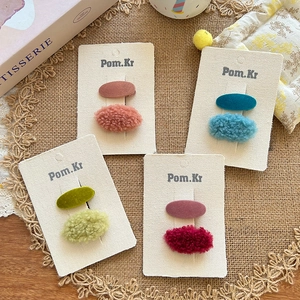 Pastel lamb wool hair clip set with matte finish, displayed on a rustic lace background