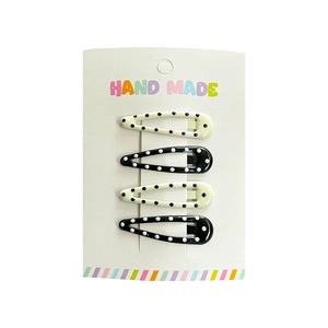 Set of 4 polka dot star water drop hair clips for children on a white display card