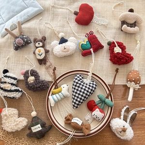 Flat lay of handmade fabric charms with lace and pearls in various cute animal shapes