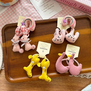 Cute cartoon plush scrunchies set featuring animals like bunny and giraffe on a wood tray
