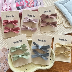 Detailed set of velvet bow hair clips for kids in six trendy muted colors on display cards