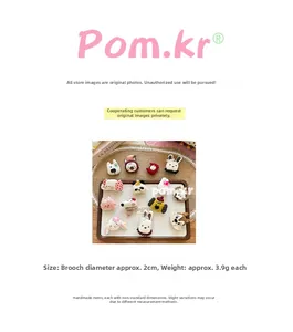 Detailed size view of handmade 2cm knitted bear and bunny brooch pins for clothing