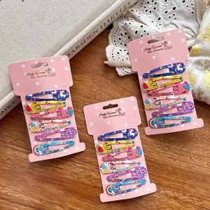 Cute cartoon print snap hair clips set with rainbow and unicorn patterns on wood