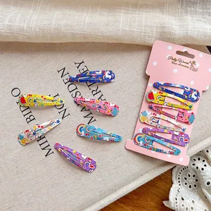 Cute cartoon drop hair clips with unicorn and rainbow prints on natural canvas background