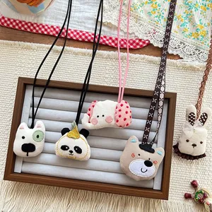 Detail of cute animal fabric pendants with exquisite embroidery and woven neck ropes